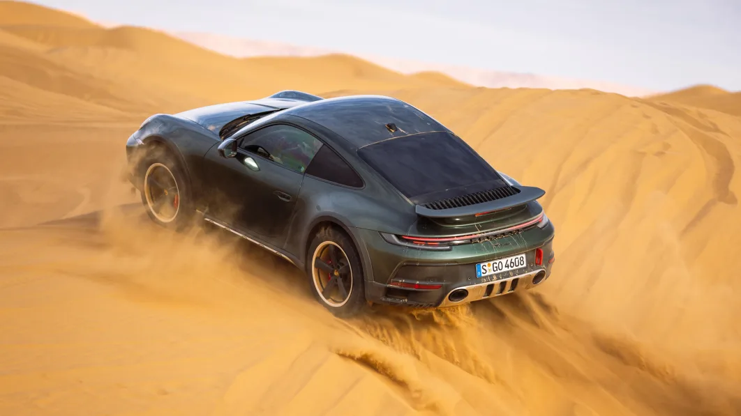2023 Porsche 911 Dakar in Oak Green action uphill on dune